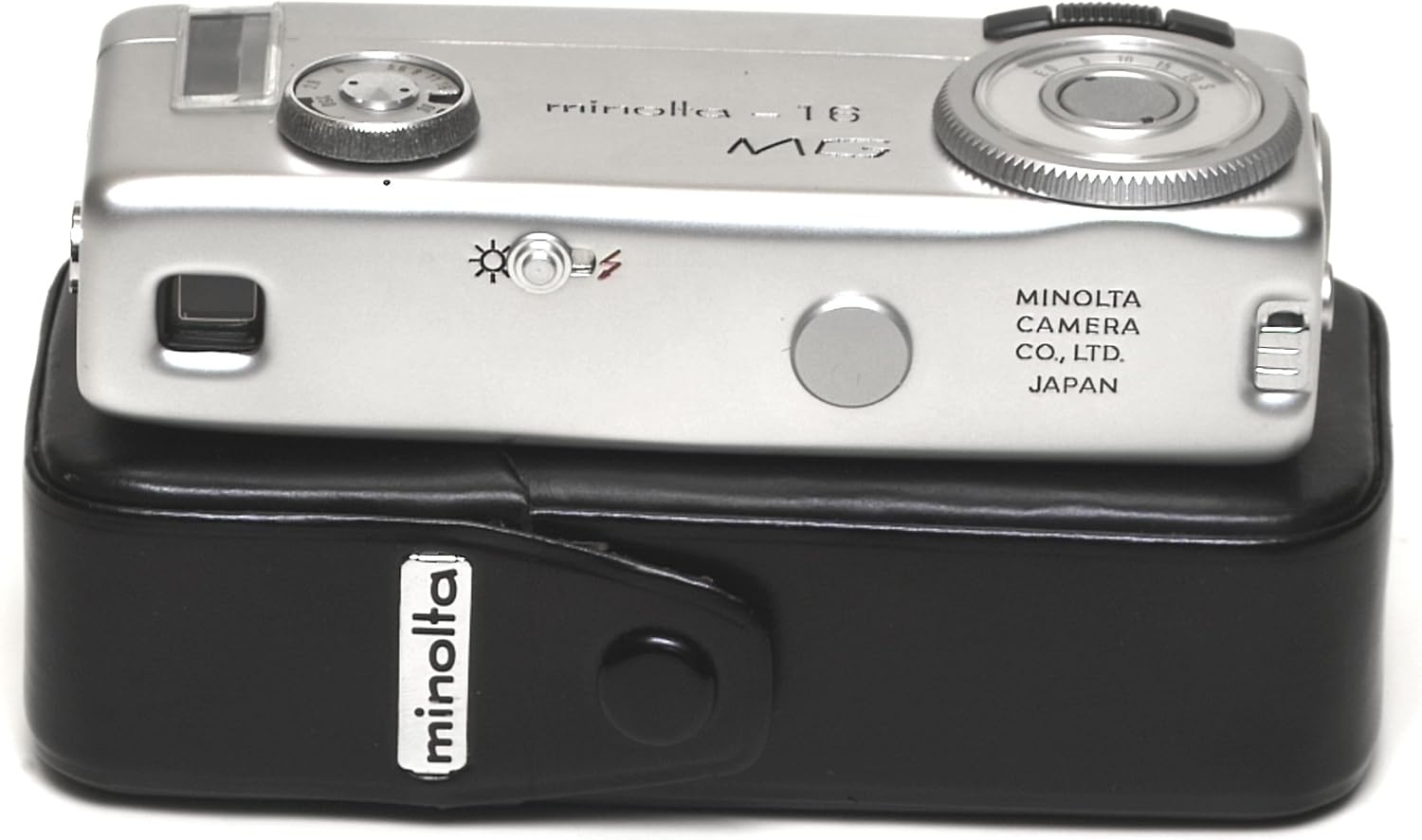 A dalt view of the Minolta 16-MG camera showing the film advance wheel and other controls
