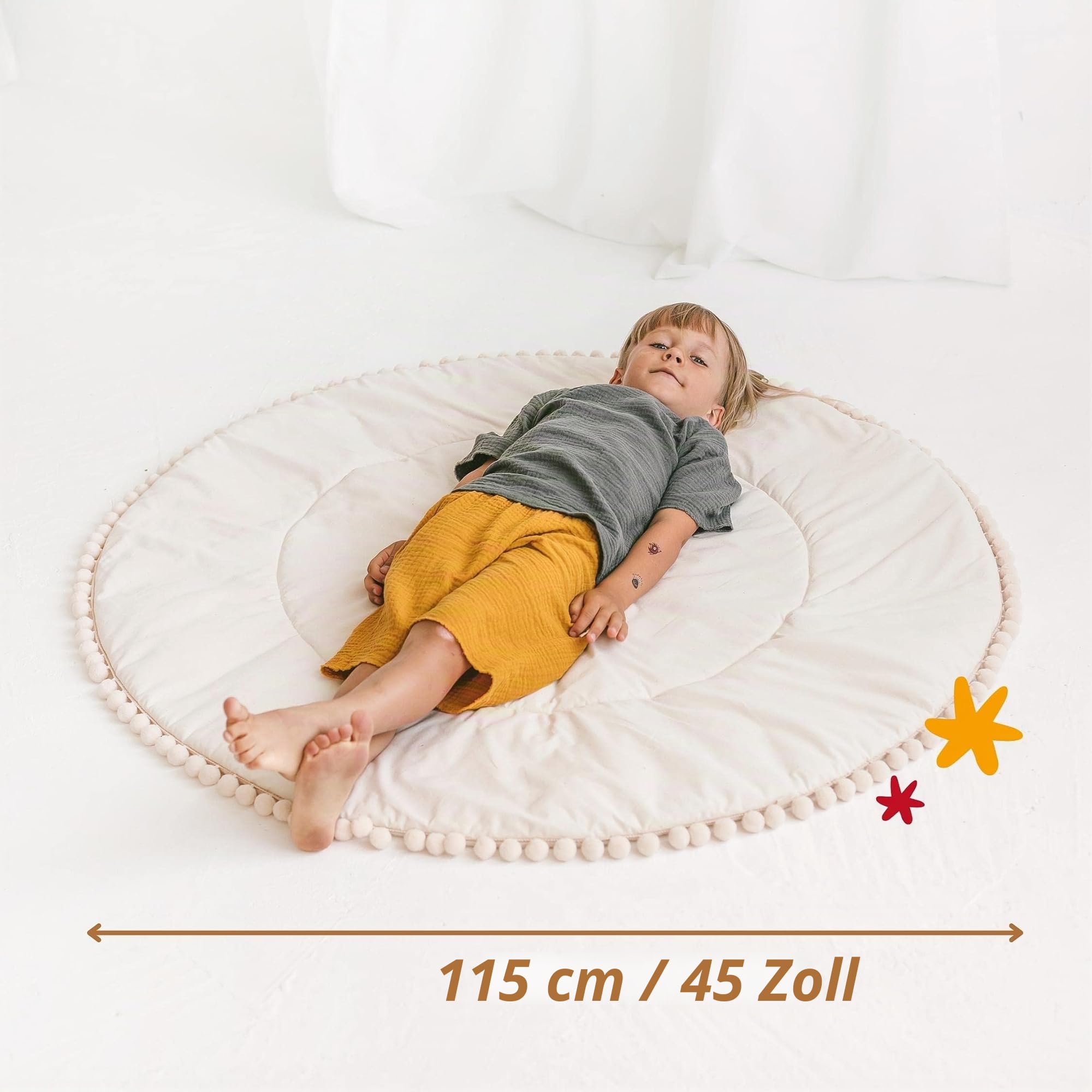 MINICAMP Baby Spielmatte für den Boden - gepolstert - runde Bodenmatte mit Bommeln für Tipi-Zelte - Spielmatte aus 100% zertifizierter Baumwolle - Teppich fürs Kinderzimmer - 115 cm Durchmesser