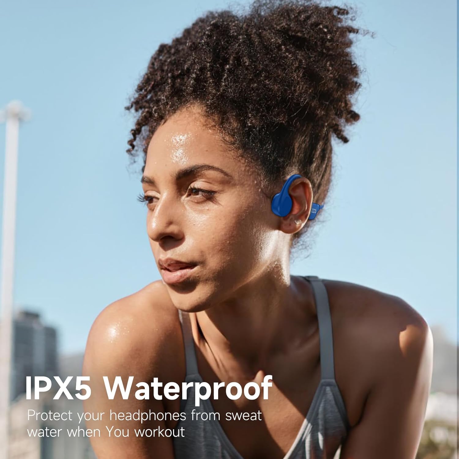 Woman sweating while exercising, wearing IFECCO headphones, demonstrating IPX5 water resistance.