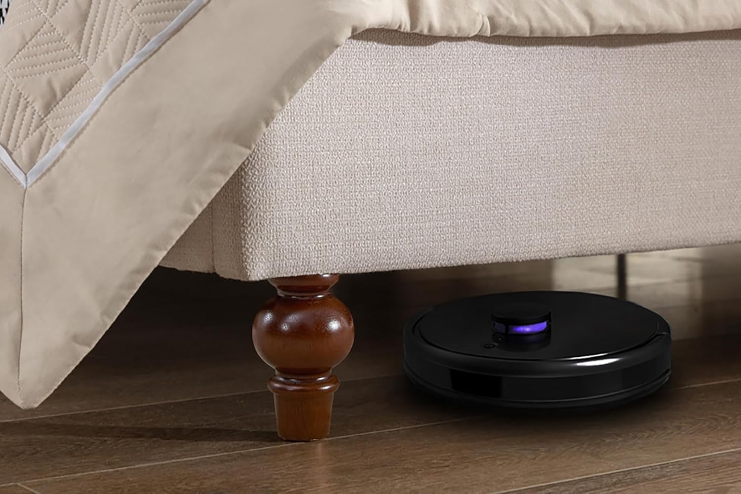 A robot vacuum cleaning under the bed, showing the clearance provided by the wooden feet.