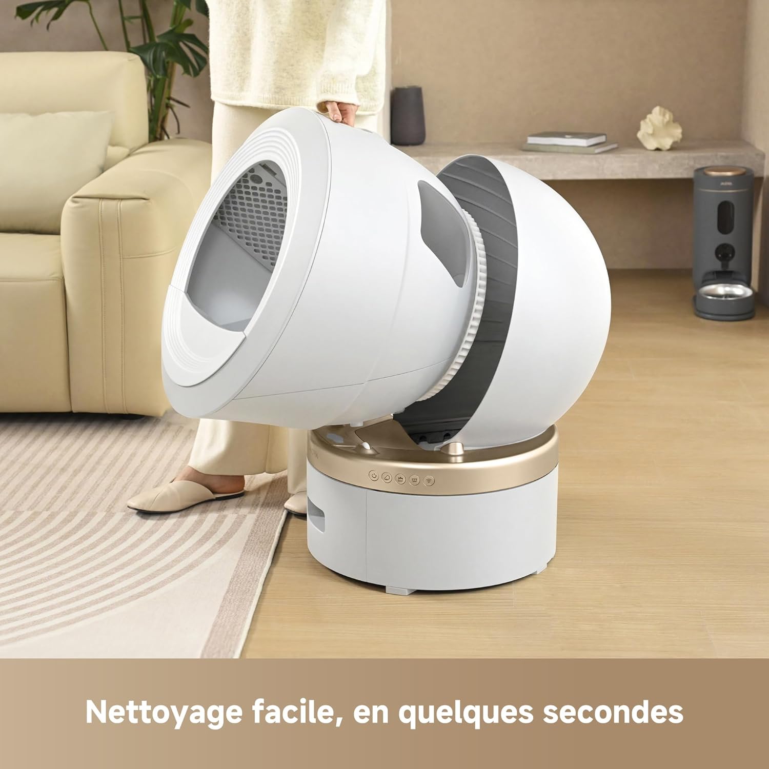 A person lifting the spherical drum of the MOVA MeowgicPod LR10 Prime for cleaning, demonstrating the easy removal.