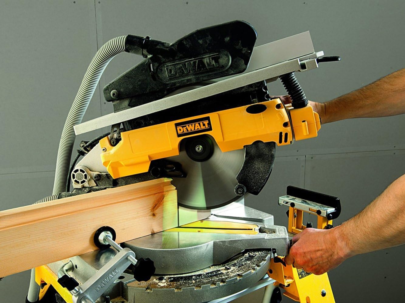 Operator making a miter cut with the DEWALT radial miter saw