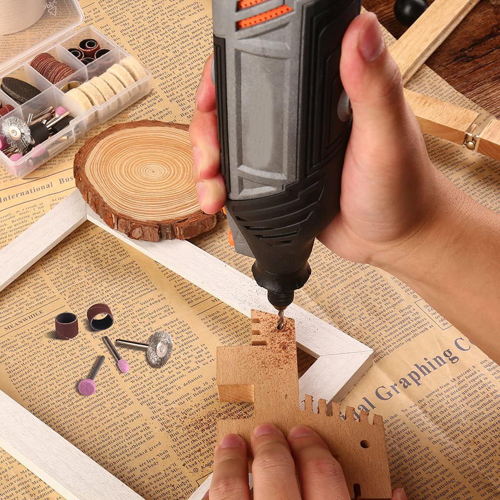 A hand using the rotary tool to engrave a design onto a piece of leather