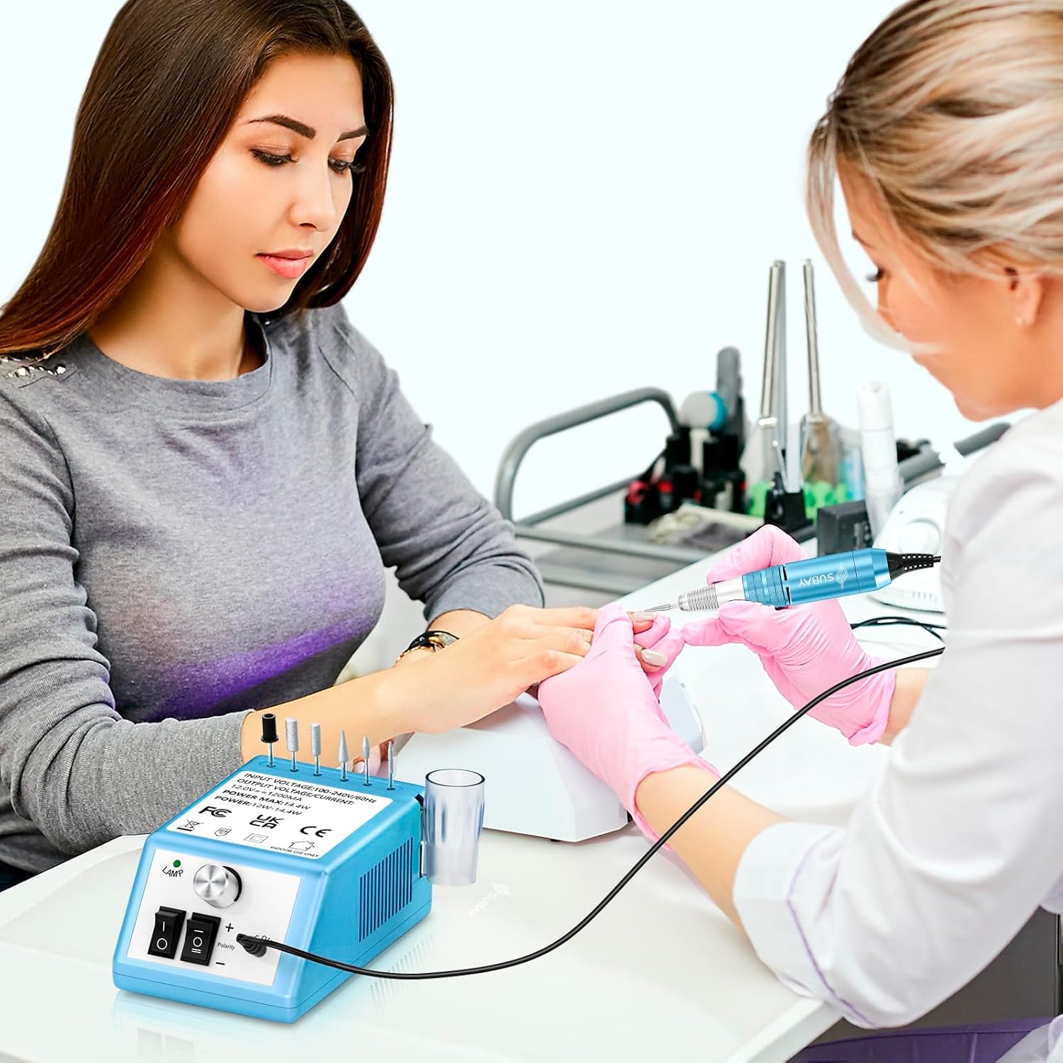 A person using the Subay nail drill on another person's nails, demonstrating its application in a salon or home setting.
