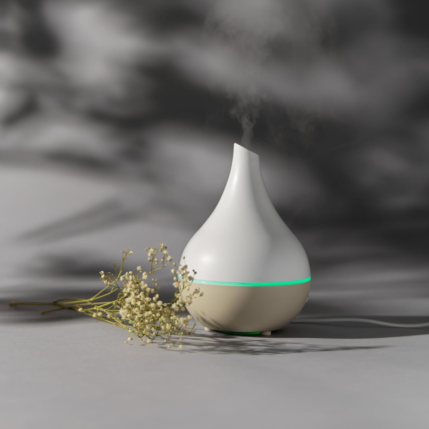 Salter Teardrop Aroma Diffuser with a plant, showing mist
