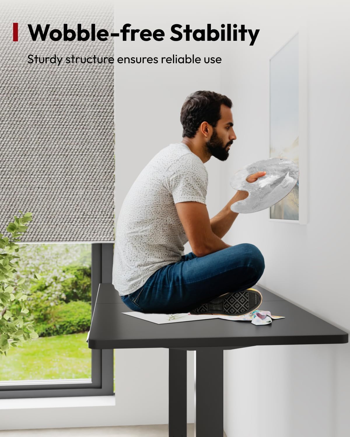 A person sitting on the desk, demonstrating its wobble-free stability.