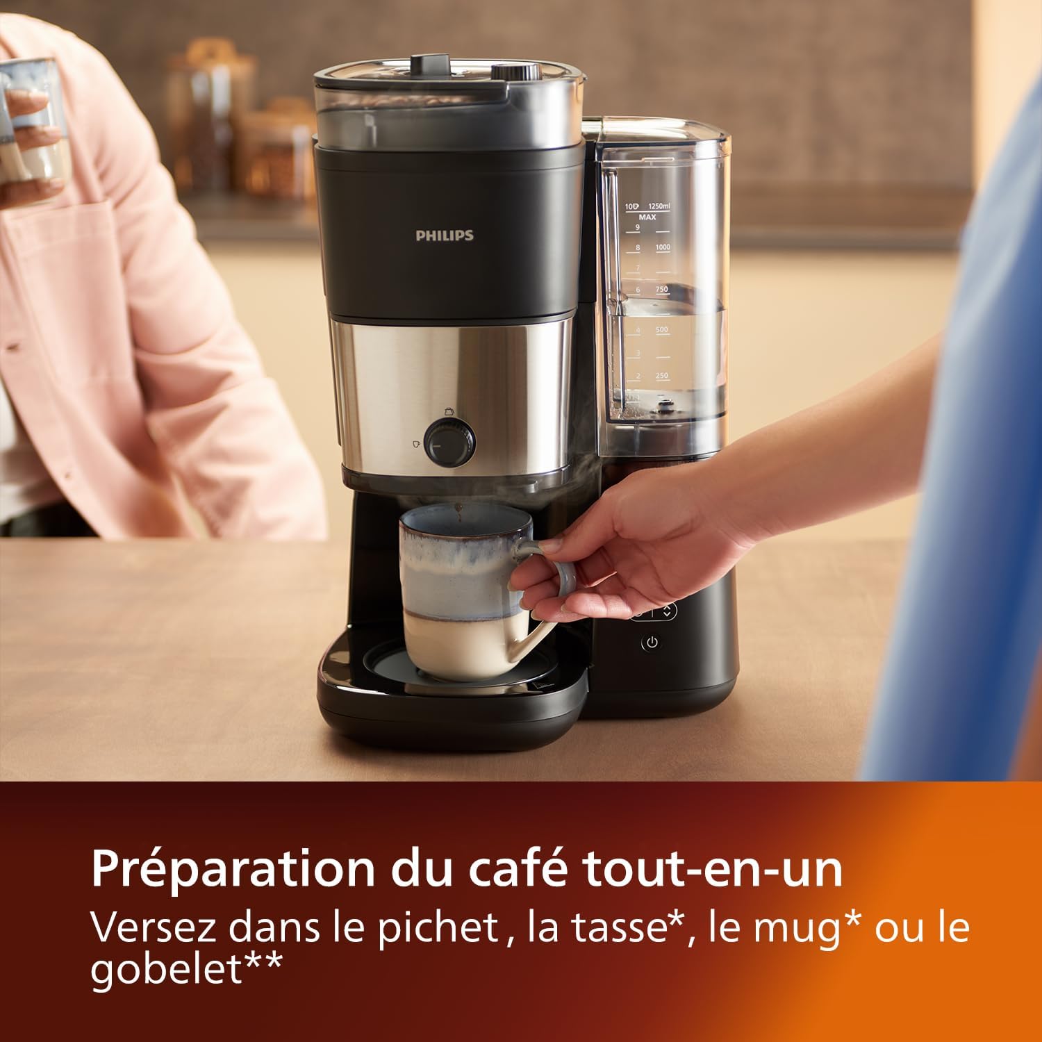Hand placing a coffee mug under the dispenser of the Philips coffee maker