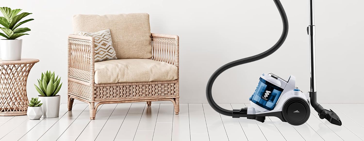 ETA 849645132 vacuum cleaner in use on a hard floor next to furniture