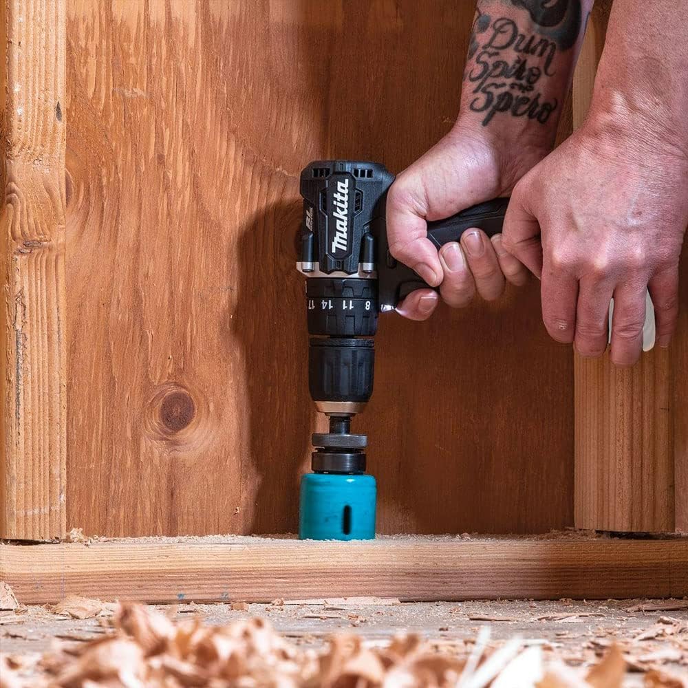A person using the Makita DDF487ZB drill/driver to drill into a wooden stud.