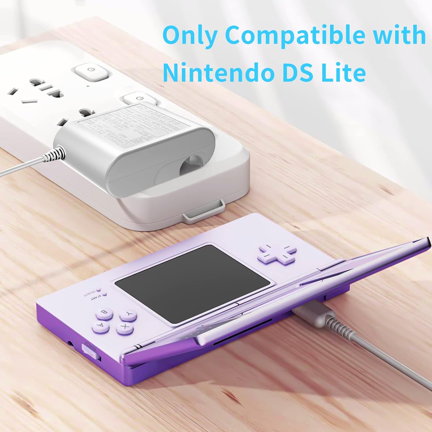 ANYQOO DS Lite Charger plugged into a power strip and connected to a purple Nintendo DS Lite console.