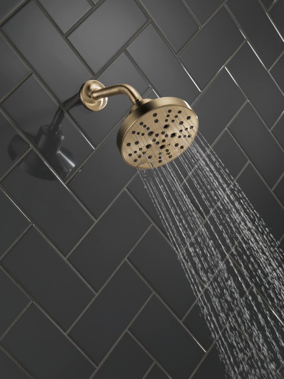 Delta 52668 shower head installed in a shower with water spraying.