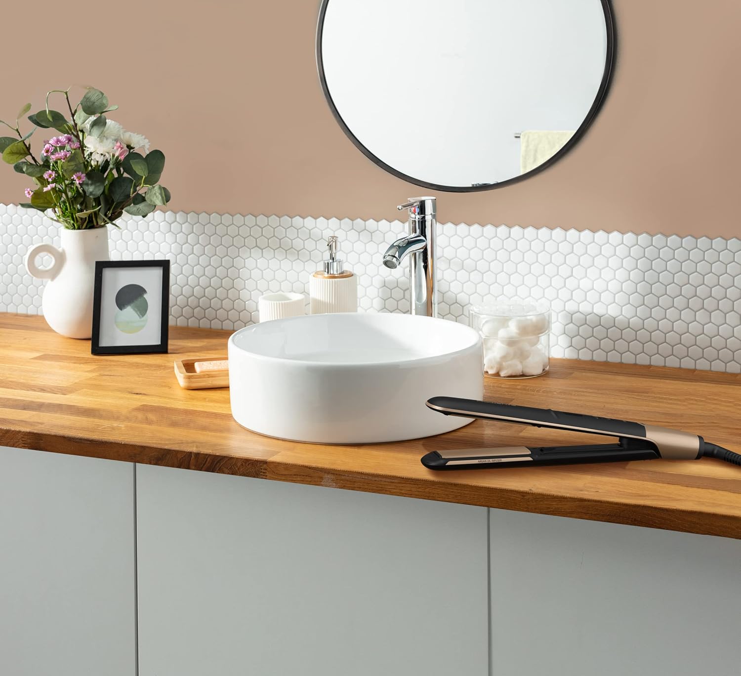 Rowenta SF4630 straightener resting on a bathroom counter next to a sink.