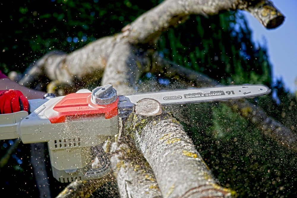 User operating IKRA IECS 2240 TF electric chainsaw to cut a tree branch