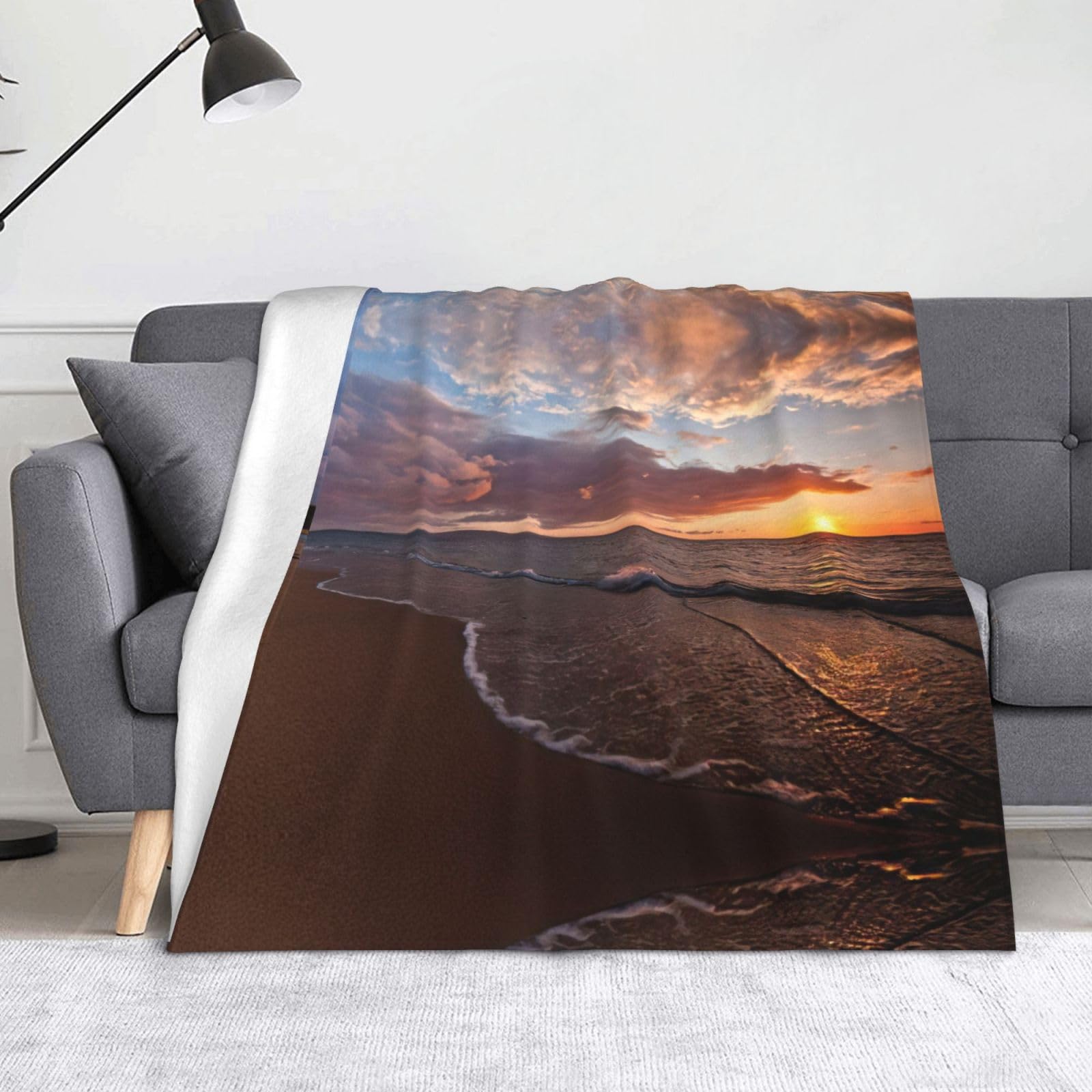 Couverture plage et coucher de soleil en peluche douce pour vos soirées d'été