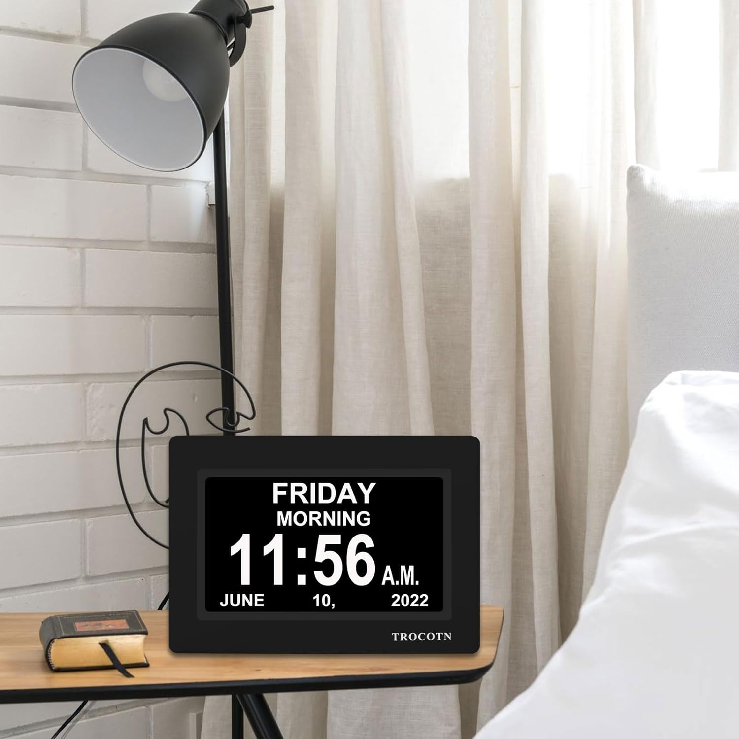 The TROCOTN 7-inch Digital Calendar Alarm Clock displaying various custom alarm labels such as 'Medicine', 'Meal', 'Appointment', 'Drink Some Water', and 'Wake up'.