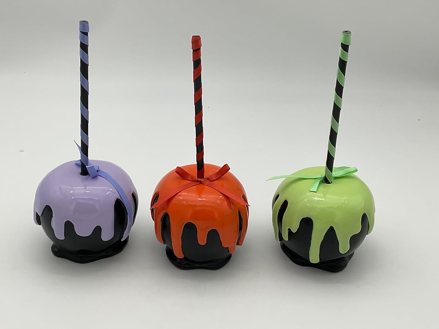 Sweet Treats Halloween Faux Candy Apples with handles wrapped in ribbon The drippings are raised comes in a set of 3 purple, orange and green 9" Tall x 3" Round Non Edible Decorative Purposes Only