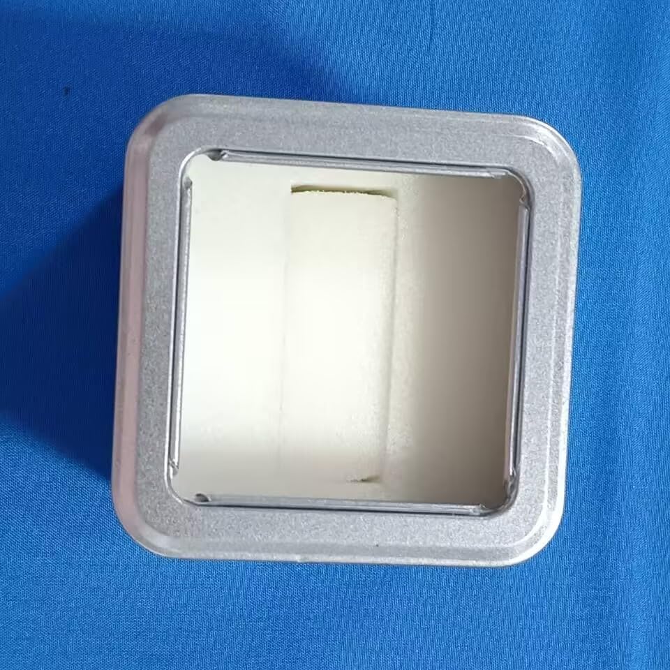 Warning labels on the bottom of the watch's tin packaging, showing battery warning, choking hazard, and not for children under 3 years symbols.