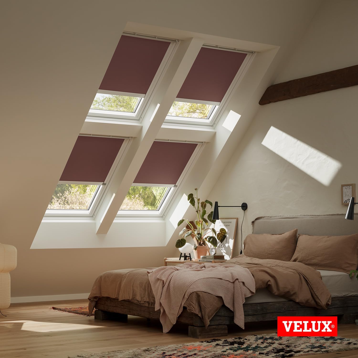 VELUX blackout blinds partially open, allowing some light into the room.