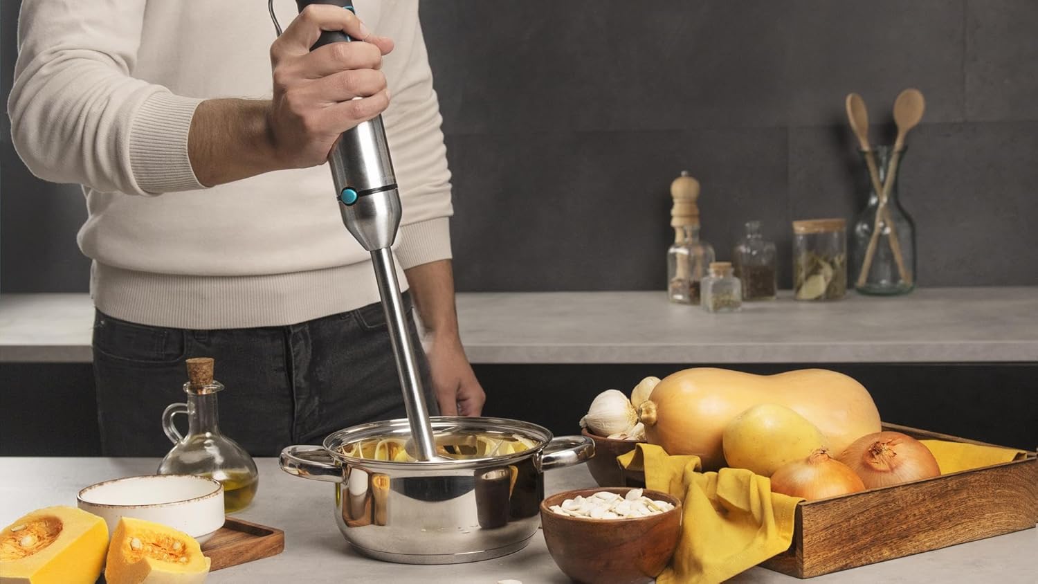 Person using the Cecotec Power TitanBlack 1500 XL Immersion Blender in a cooking pot
