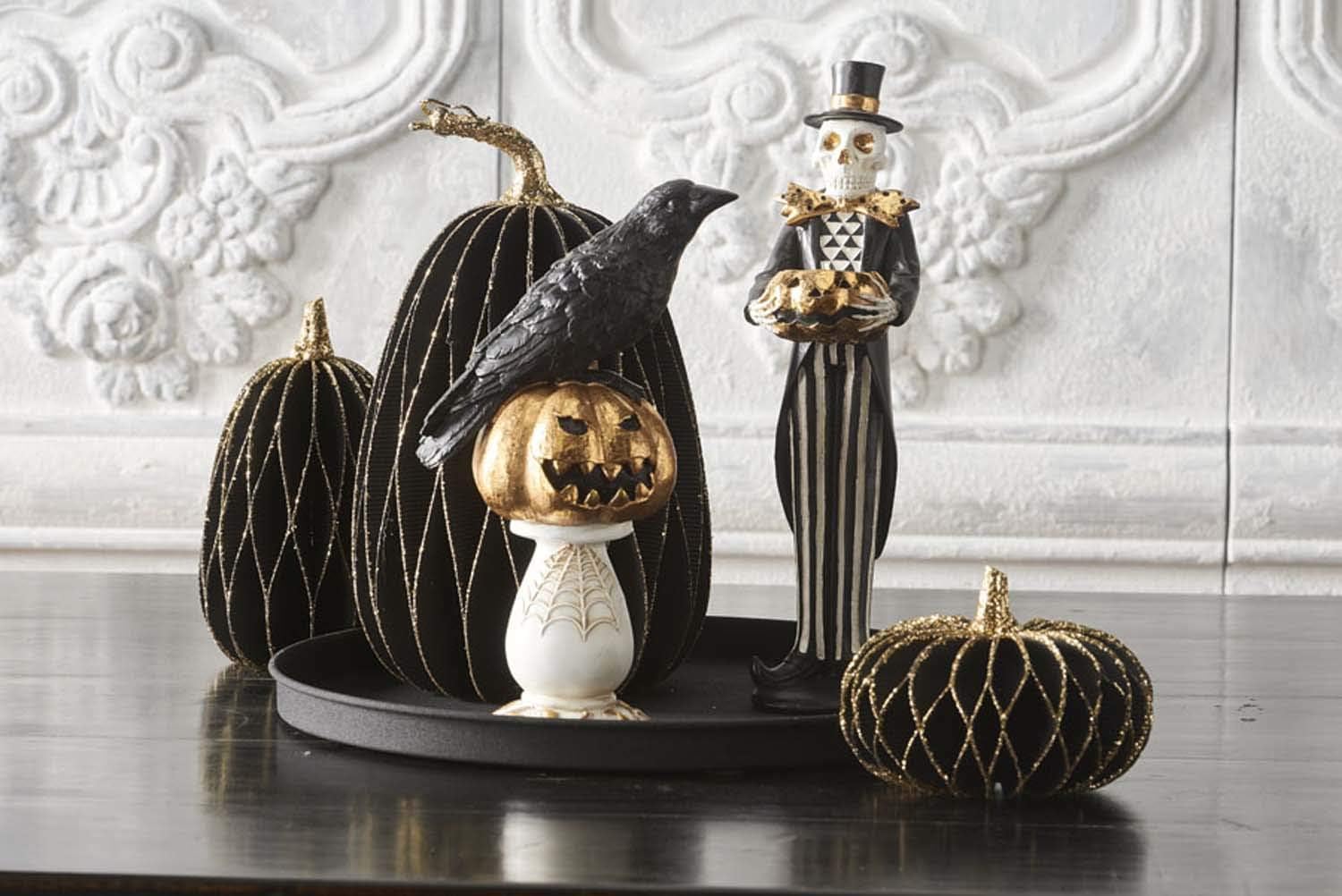 13 Inch Black and Gold Skeleton Holding Gold Jack O Lantern
