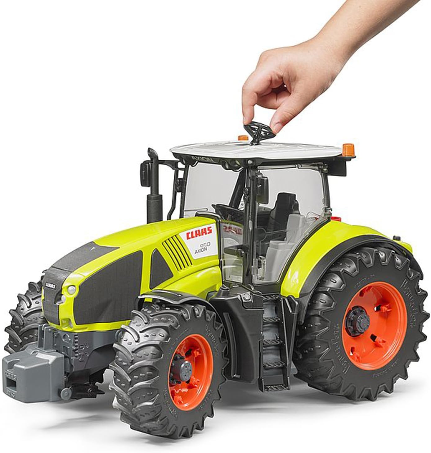 Image showing the bruder Claas Axion 950 toy tractor with its engine hood open, revealing engine details.