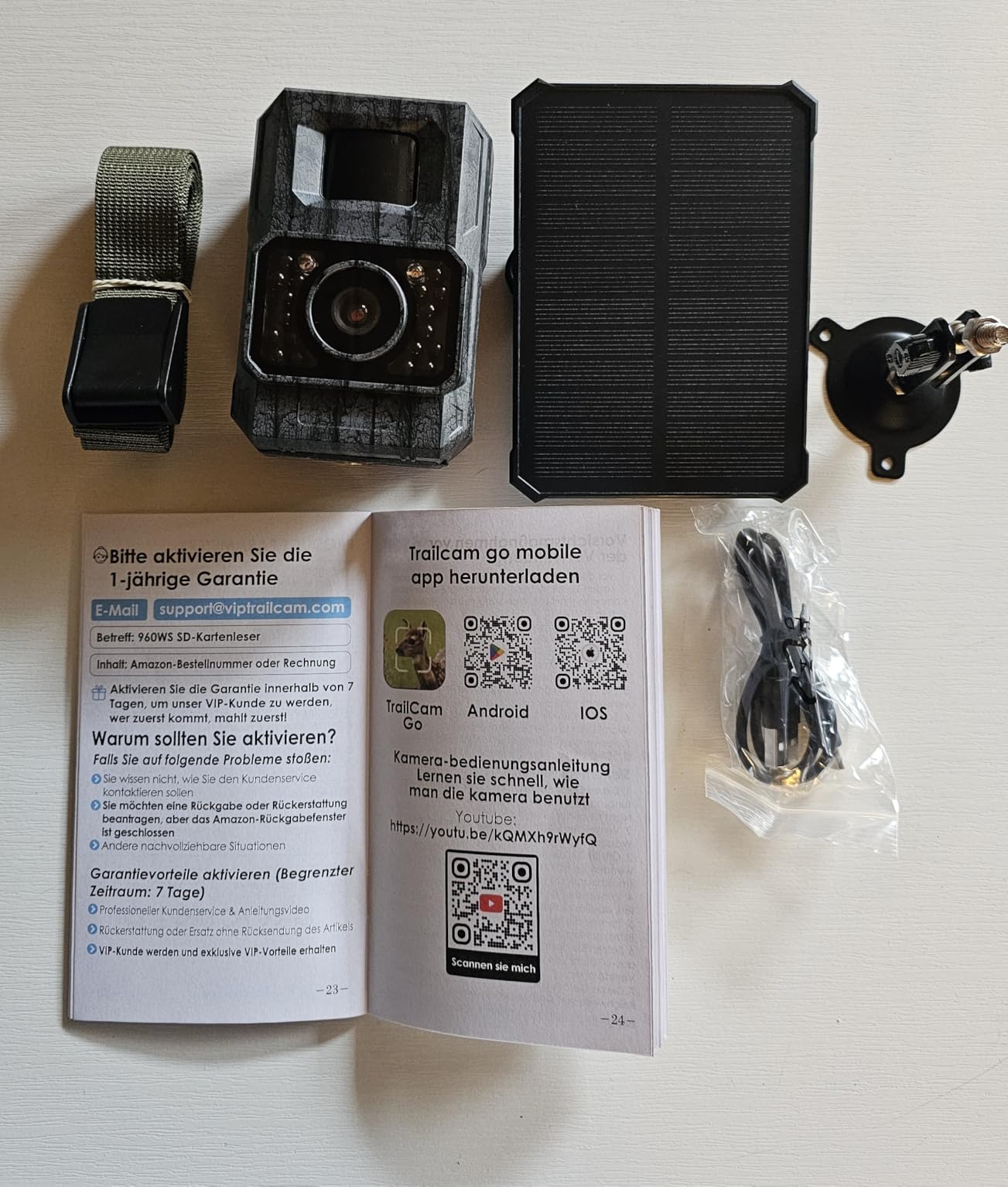 MAXDONE PH960W-SGE Trail Camera secured to a tree using a mounting strap.