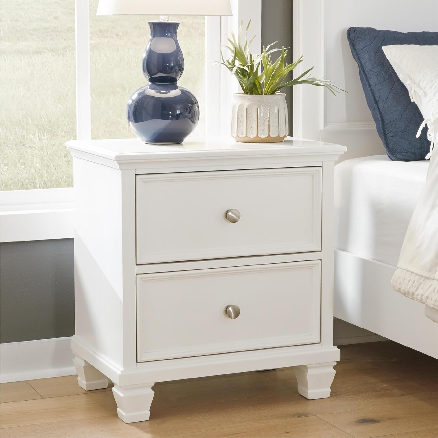 Signature Design by Ashley Fortman White Nightstand, 2 Drawer Storage, Hardwood Solids and MDF Construction, Traditional Wood Bedside Table, 25" W | Hardwood solids and MDF substrate, Smooth-gliding closed storage, Ideal for master and guest rooms