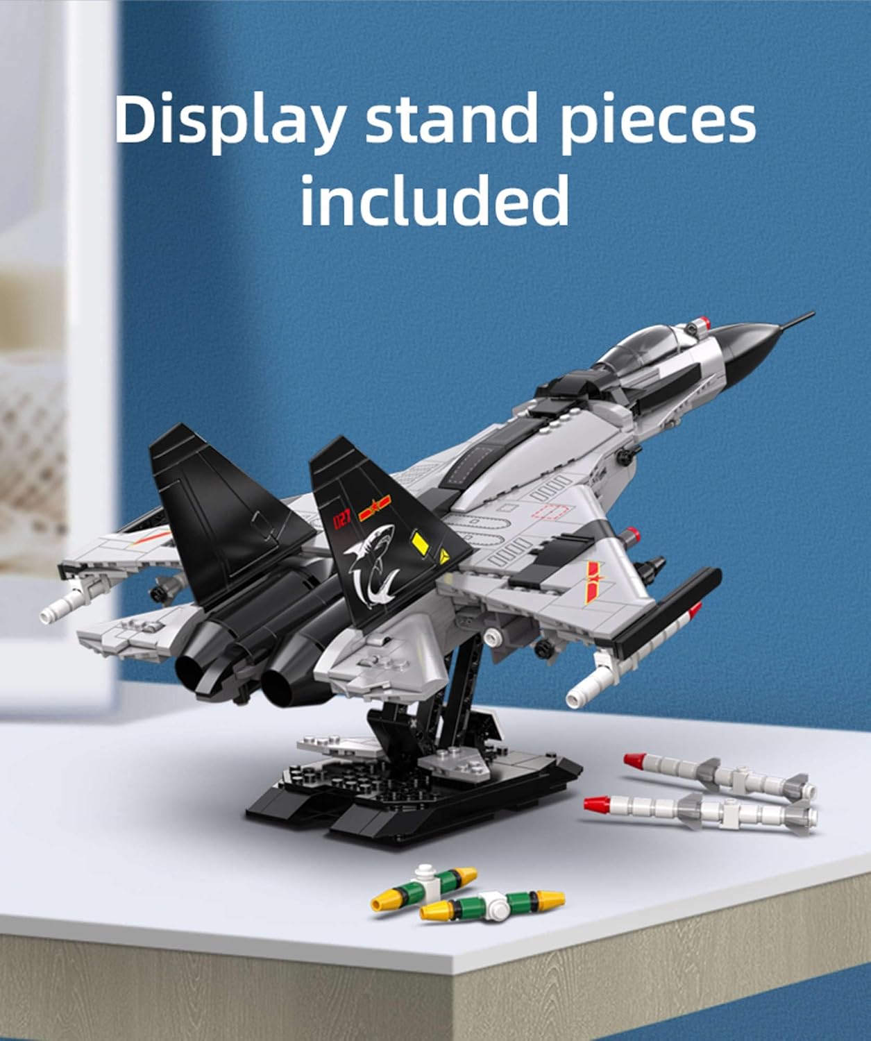 Assembled fighter jet on display stand with loose missile pieces