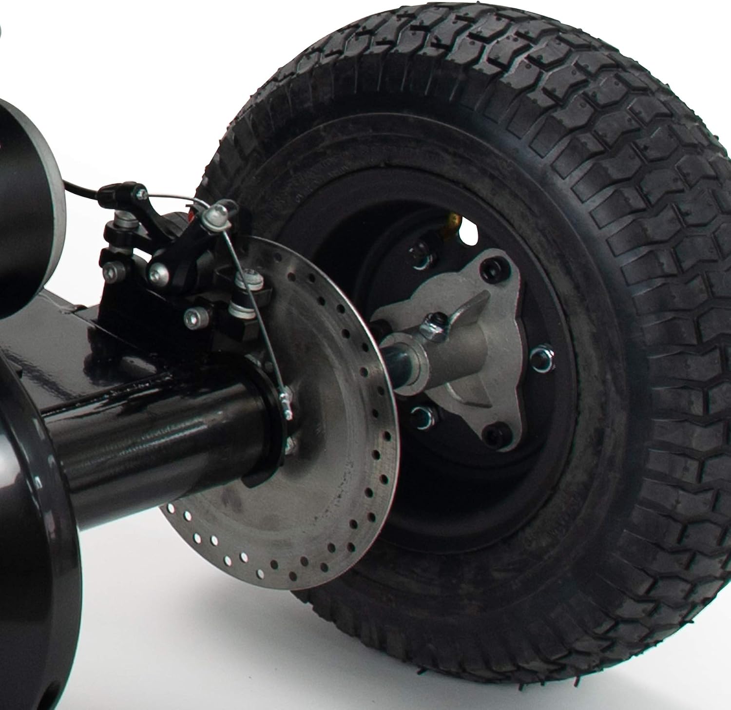 Close-up of the rear disc brake and wheel on the INJUSA X-Treme Zero 24V Electric Quad.