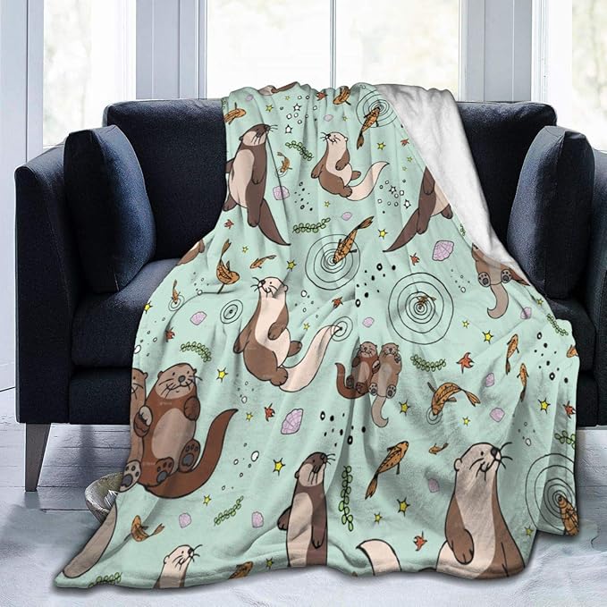 Light green throw blanket with otters on it, a few fish as well.