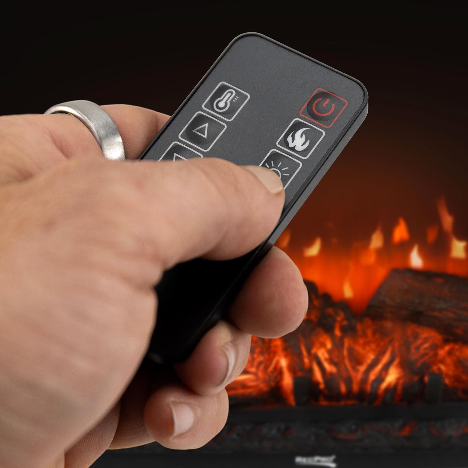 Hand holding the remote control for the RecPro RV Electric Fireplace