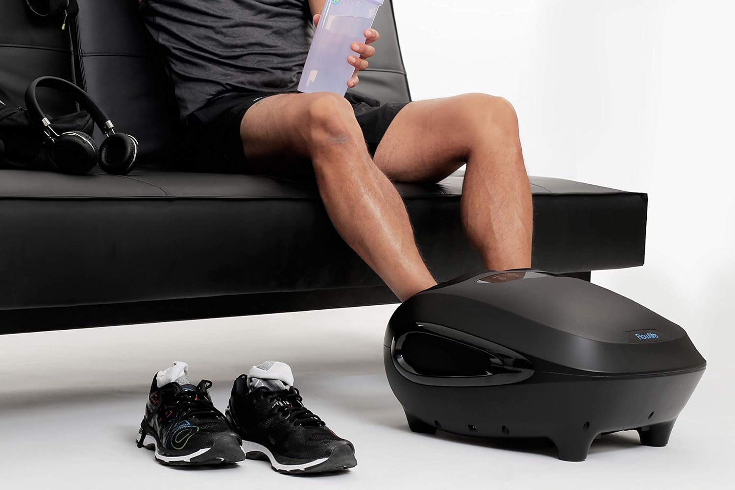 Person using Flowlife Flowfeet Foot Massager while sitting on a couch