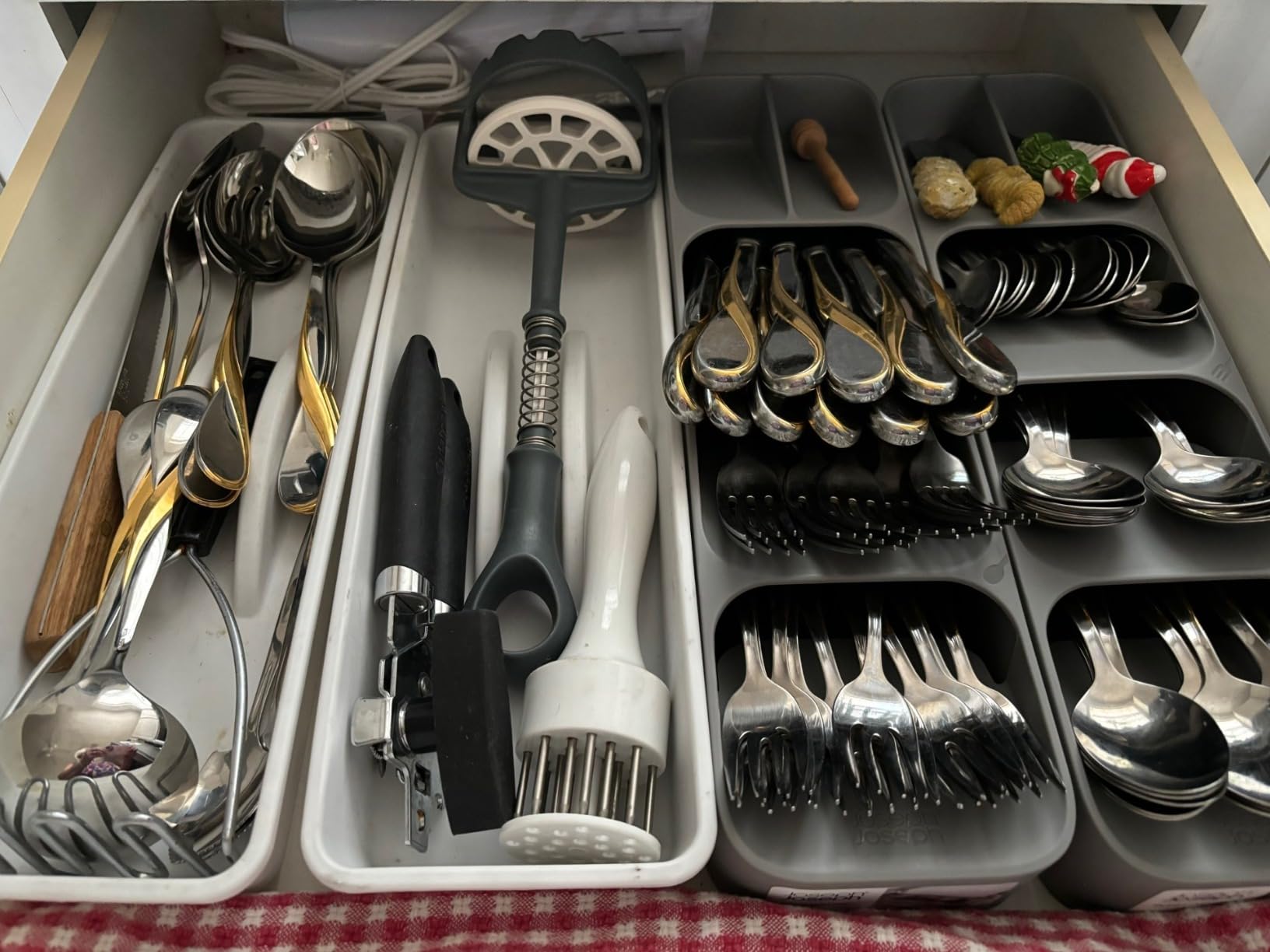Compact cutlery organizer in a small kitchen drawer