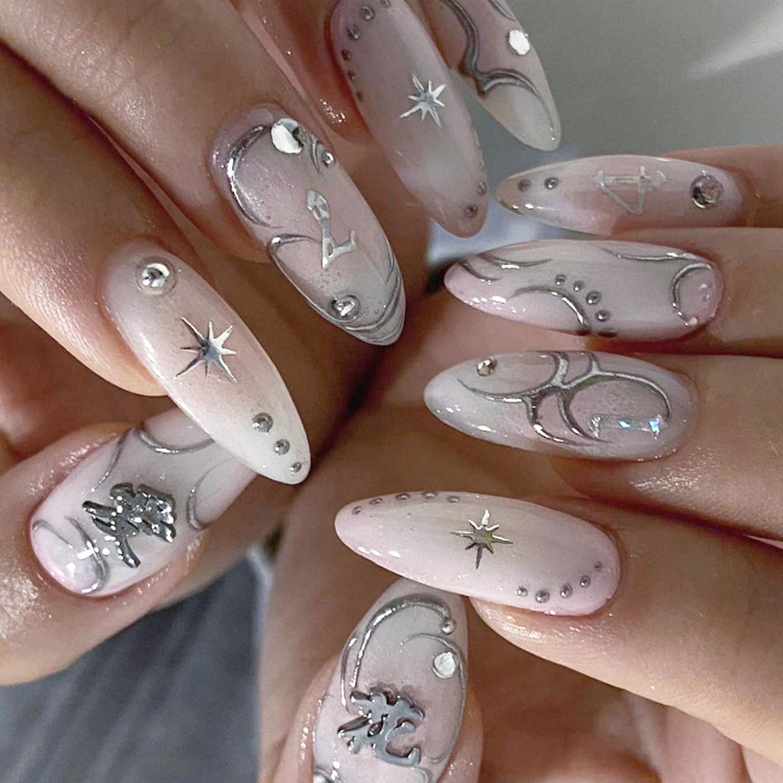 Glossy Elongated Stiletto False Nails With Intricate Silver Detailing And Sparkling Rhinestones