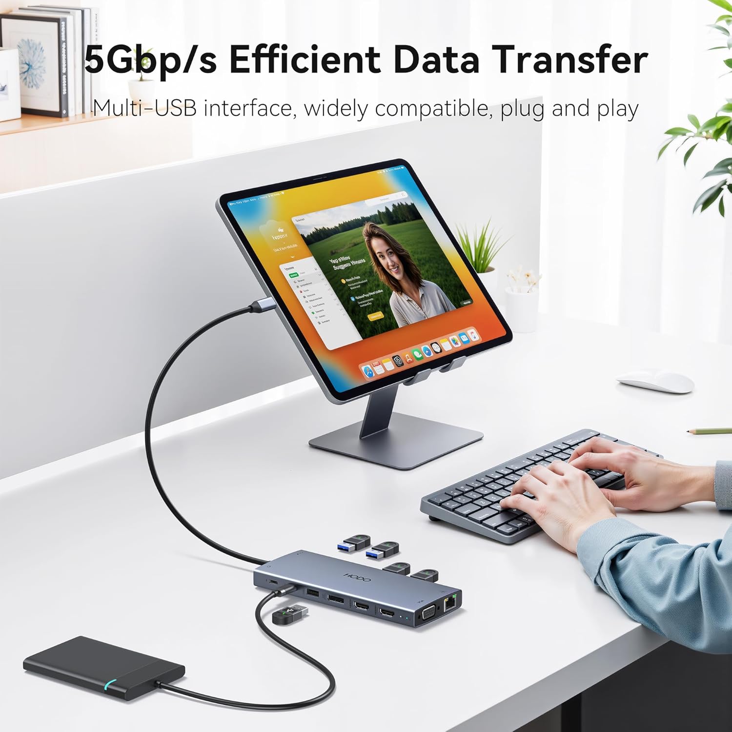 Person using the HODO docking station to transfer data from a tablet to an external hard drive.