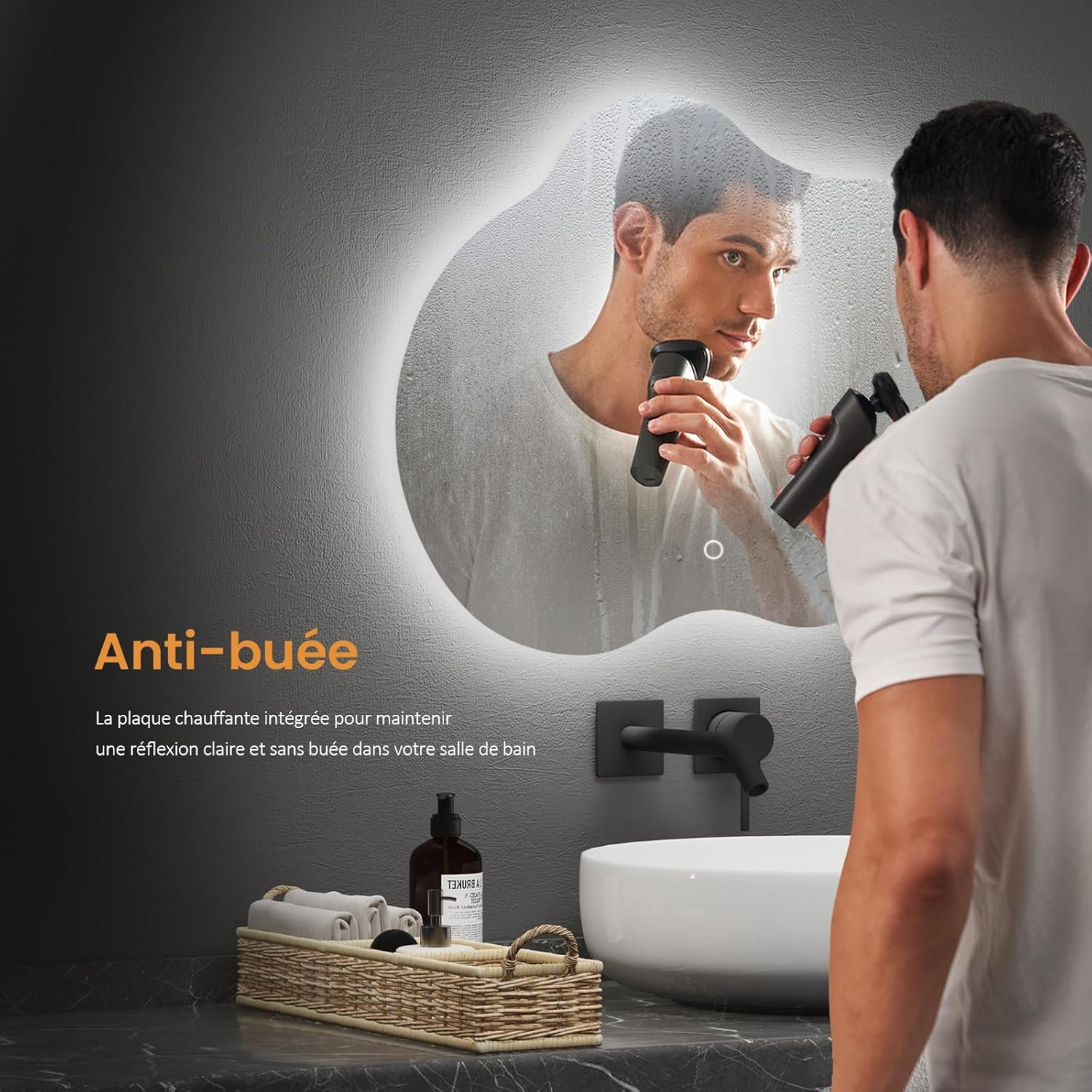 A man shaving in front of an EMKE LED bathroom mirror with the anti-fog function active, showing a clear reflection despite steam.