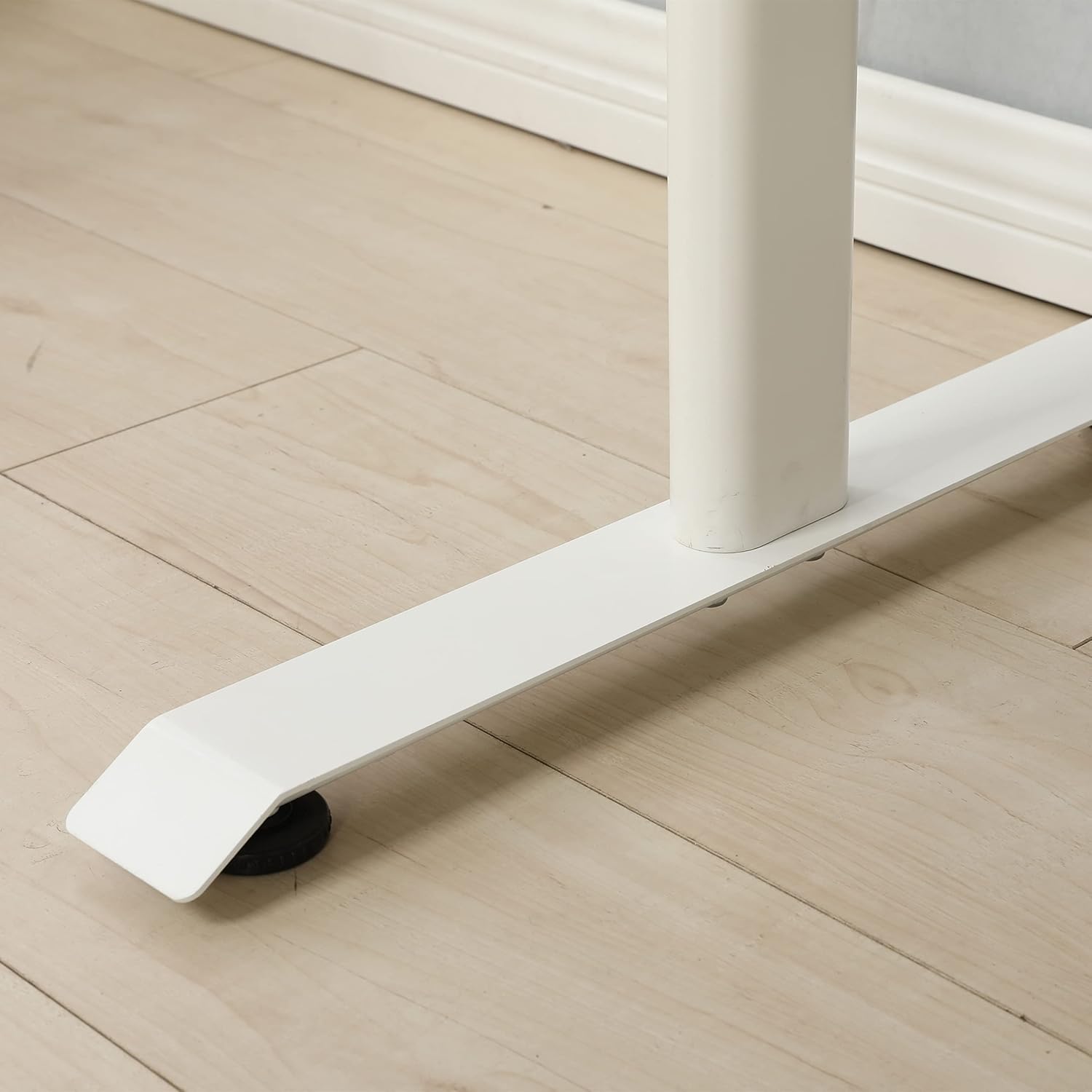 Close-up of a desk foot pad on a wooden floor