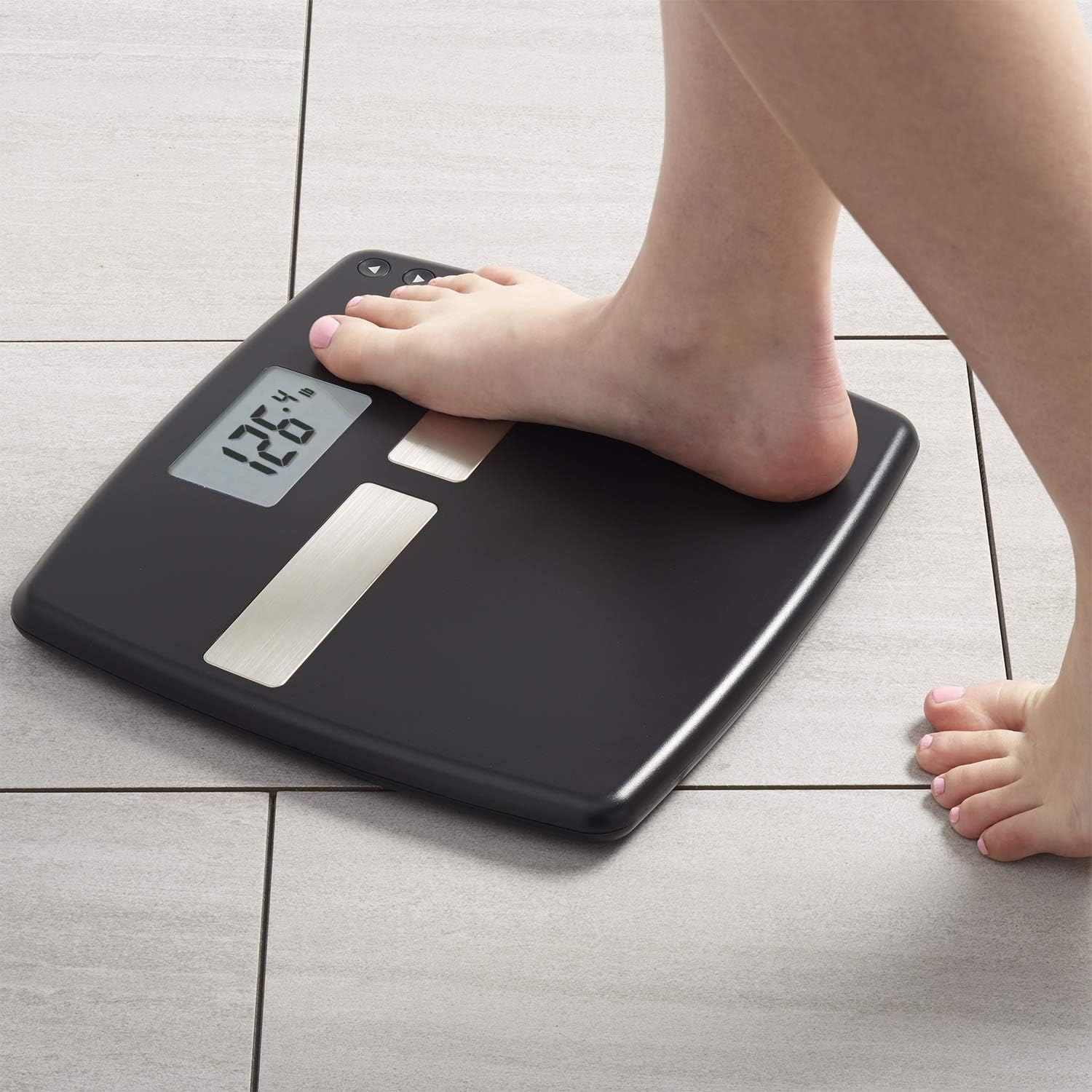 InstaTrack Digital Body Composition Scale showing a foot stepping on it, displaying a weight of 126.4 lbs.