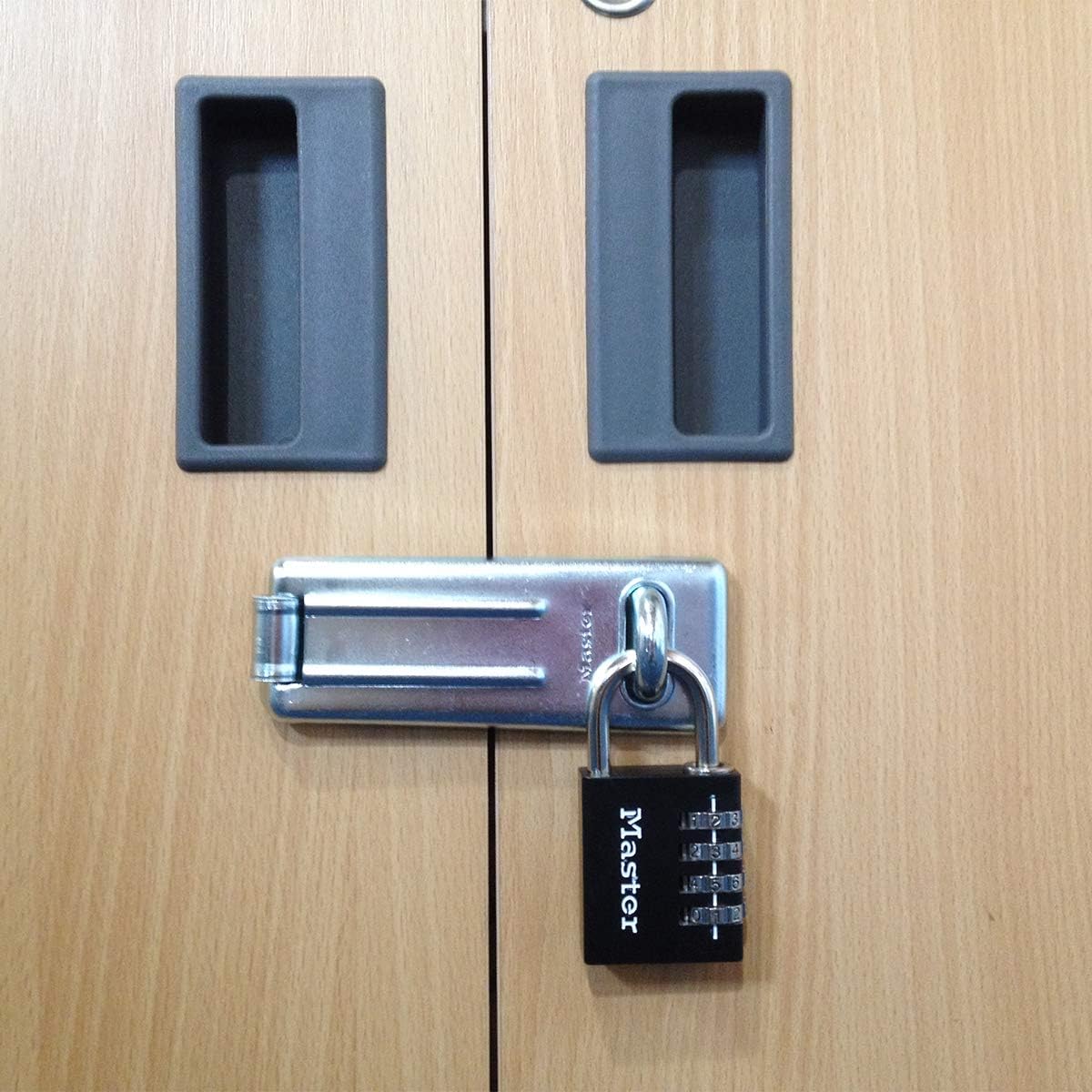 Master Lock 7640EURDBLK Padlock securing a cabinet hasp