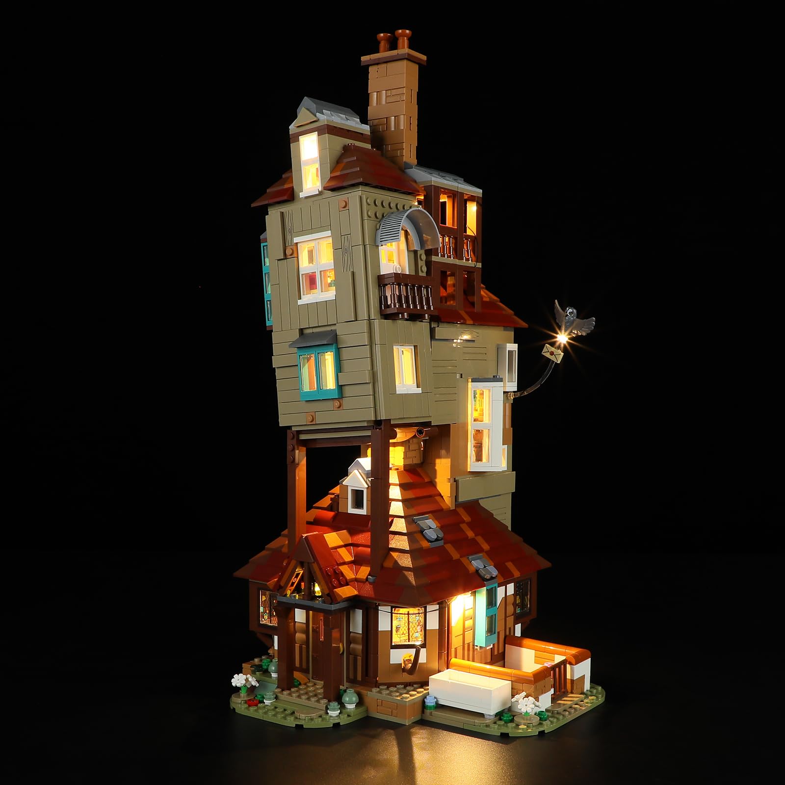 The Harry Potter The Burrow model fully illuminated with the YEABRICKS LED light kit, showcasing lights in various rooms and exterior elements.