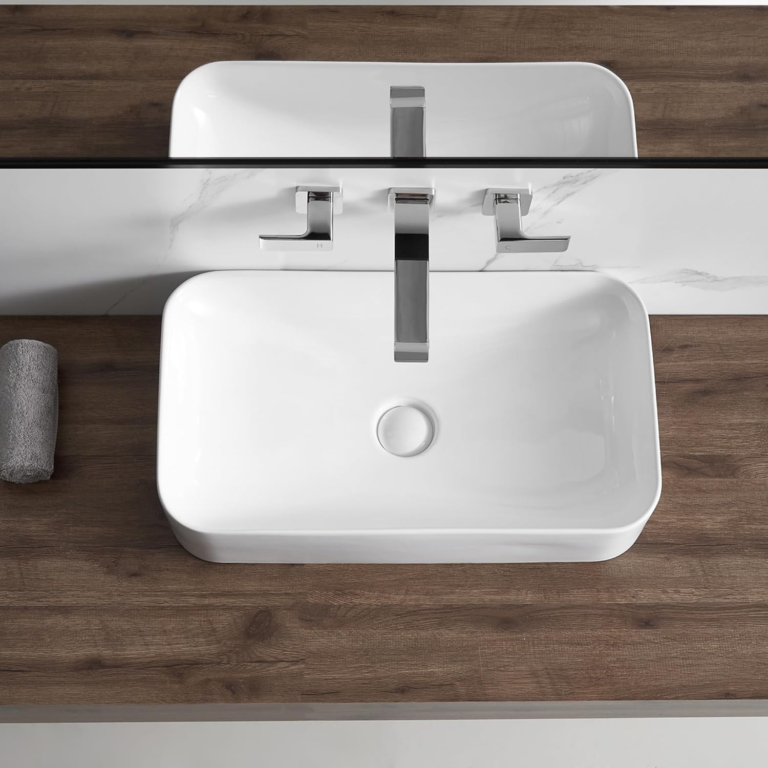 Van onder na onder view of the Eridanus BATHSNIK-011 vessel sink installed on a wooden countertop with a wall-mounted faucet.