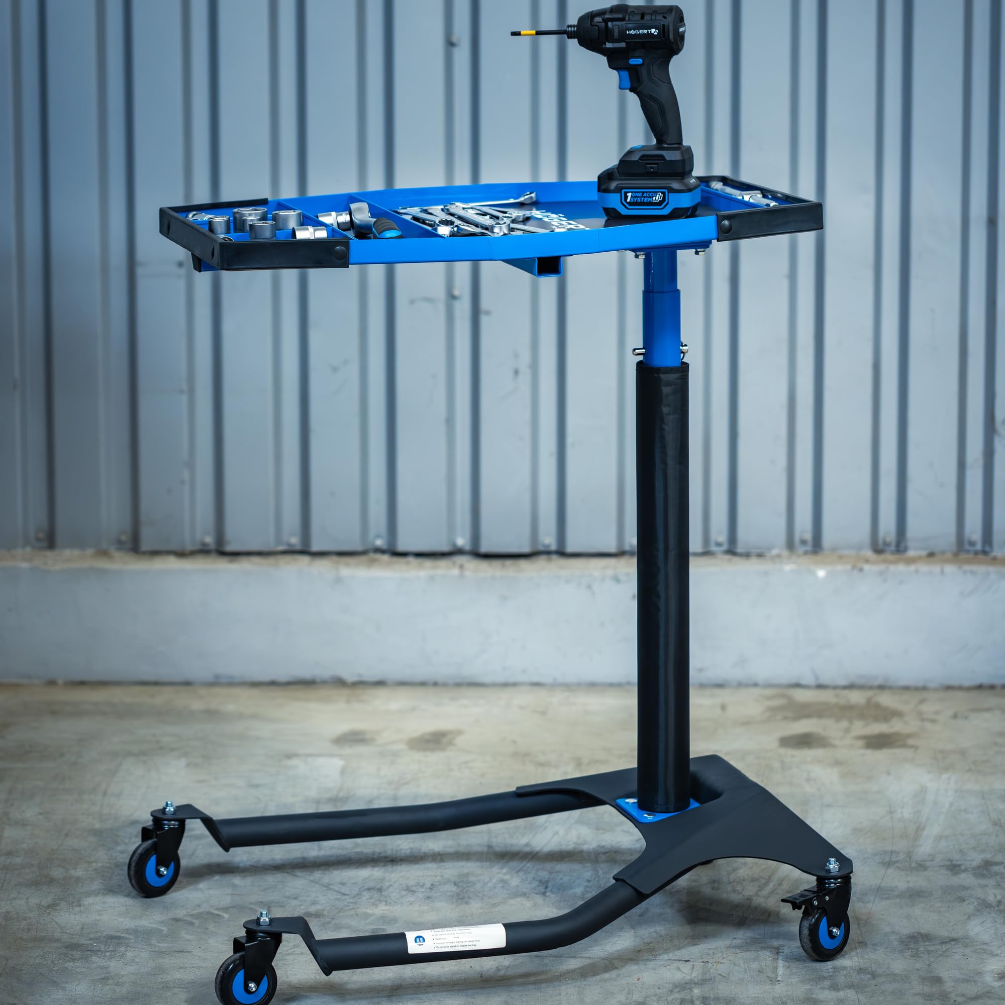 Högert Technik Mesa de Trabajo móvil HT7G564, Altura Regulable 86-120 cm, Capacidad 30 kg, Estructura en H para Taller, 4 Ruedas giratorias TPR con Freno, Azul-Negro
