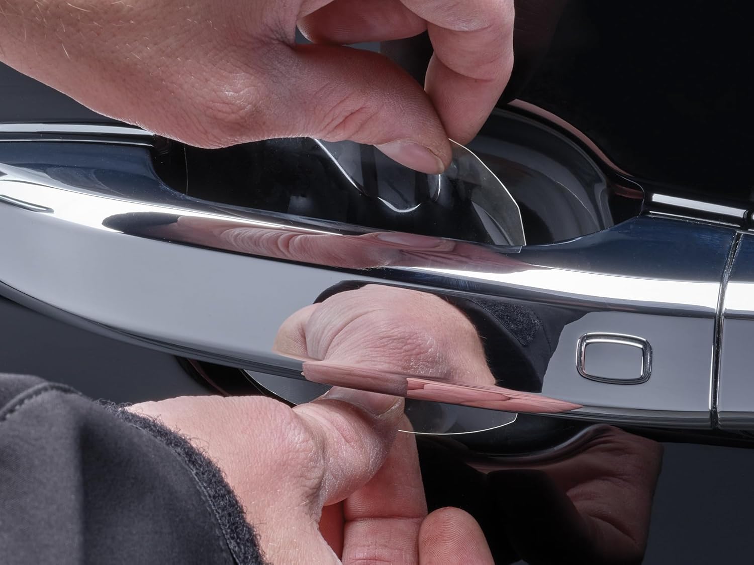 Applying protective film to a car door handle cup