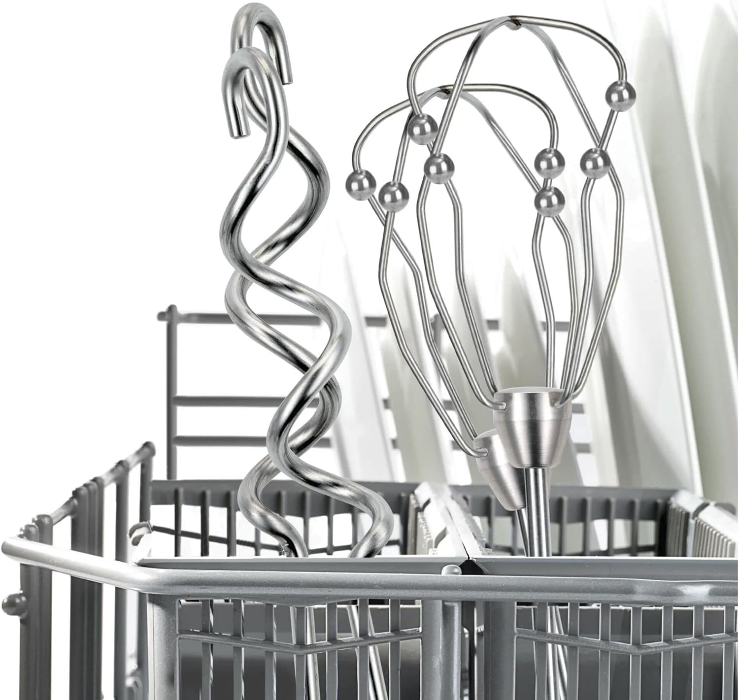 A stainless steel dough hook and a whisk placed in a dishwasher rack.