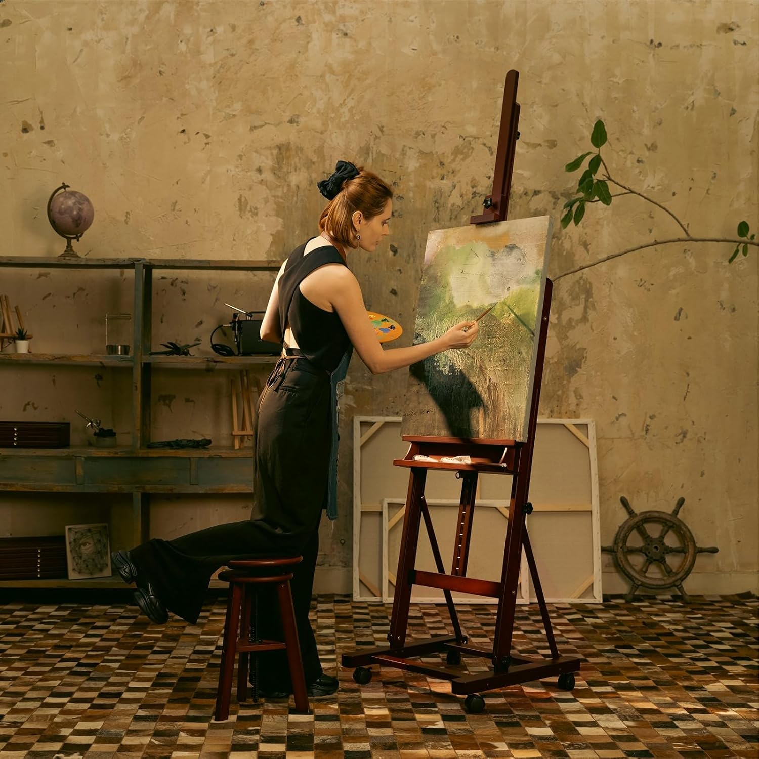 Artist painting on the MEEDEN H-Frame Easel in a studio setting.