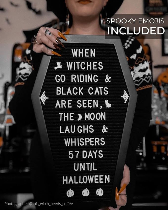 Coffin-shaped black letter board with emojis and bat stickers