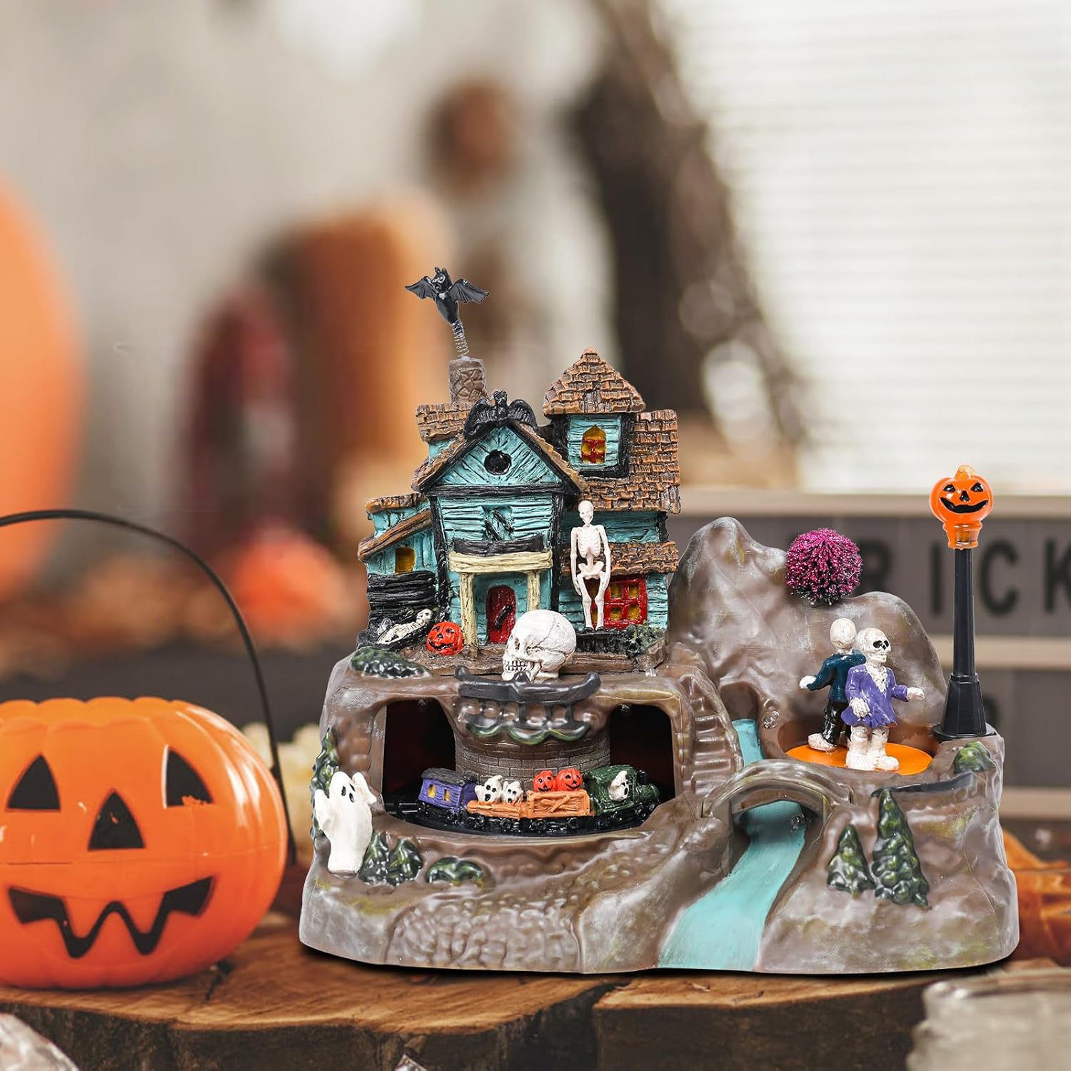 Halloween Village House Decorations 8.8 inch Lighted Haunted House with Animated Train Skull Ghost Bat Pumpkin Statue Scary Music Halloween Village Figurine Party Holiday Collection Table Indoor Decor
