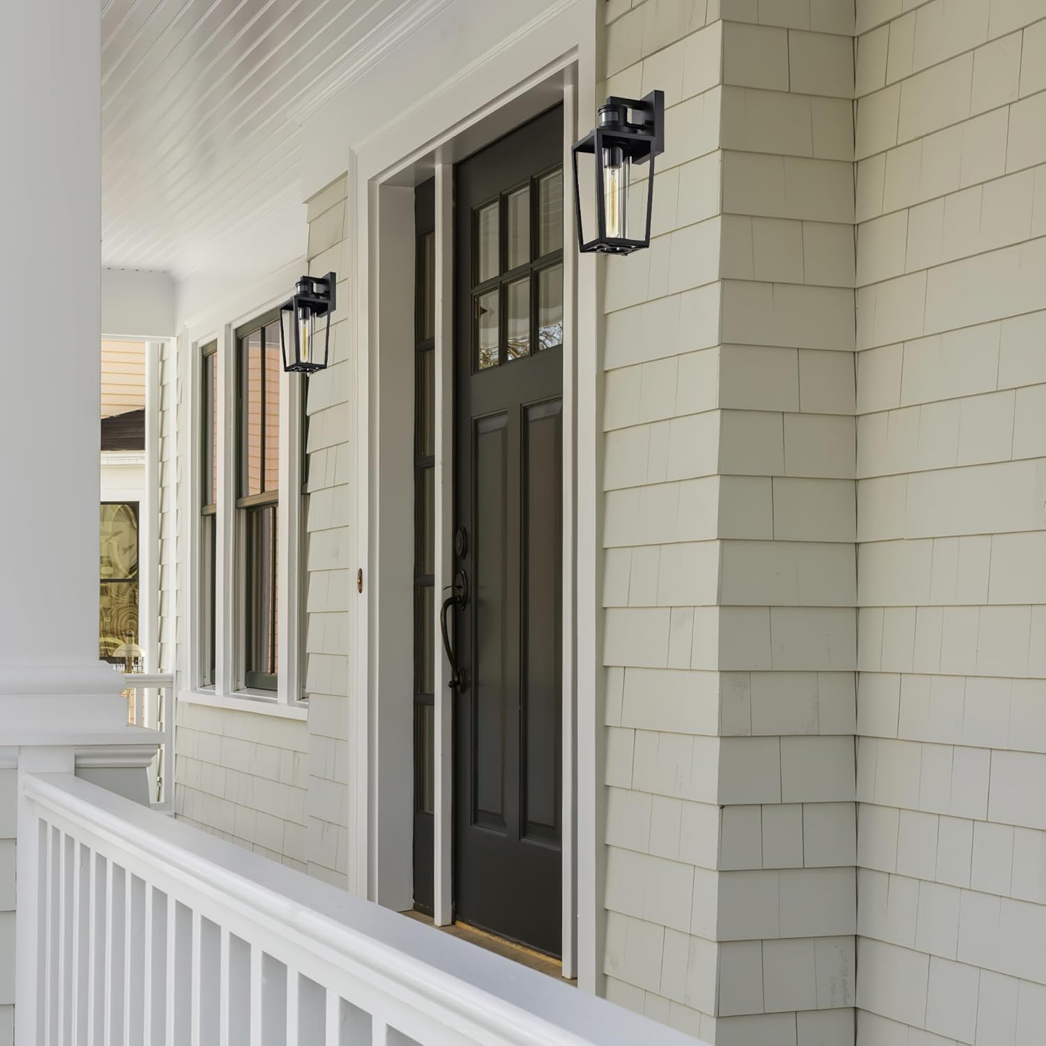 Two Edvivi outdoor wall lights installed on a house exterior near a front door and railing