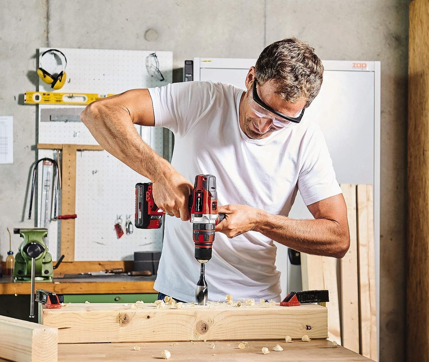 Person using Einhell Cordless Impact Driver to drill into a wooden beam