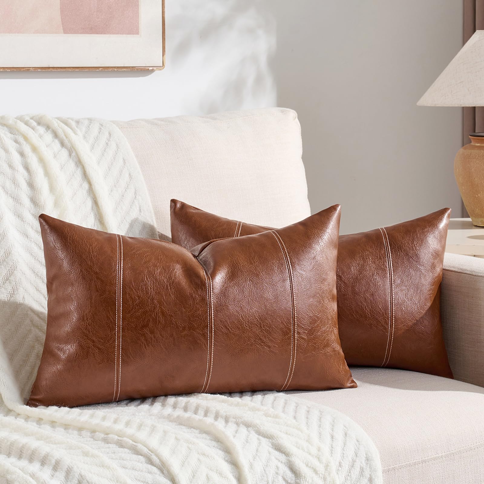 Photo 1 of Fancy Homi 2 Packs Brown Boho Lumbar Faux Leather Decorative Throw Pillow Covers 12x20 Inch for Living Room Couch Bed Sofa, Hand Stitched Rectangle Cushion Case, Rustic Modern Farmhouse Home Decor